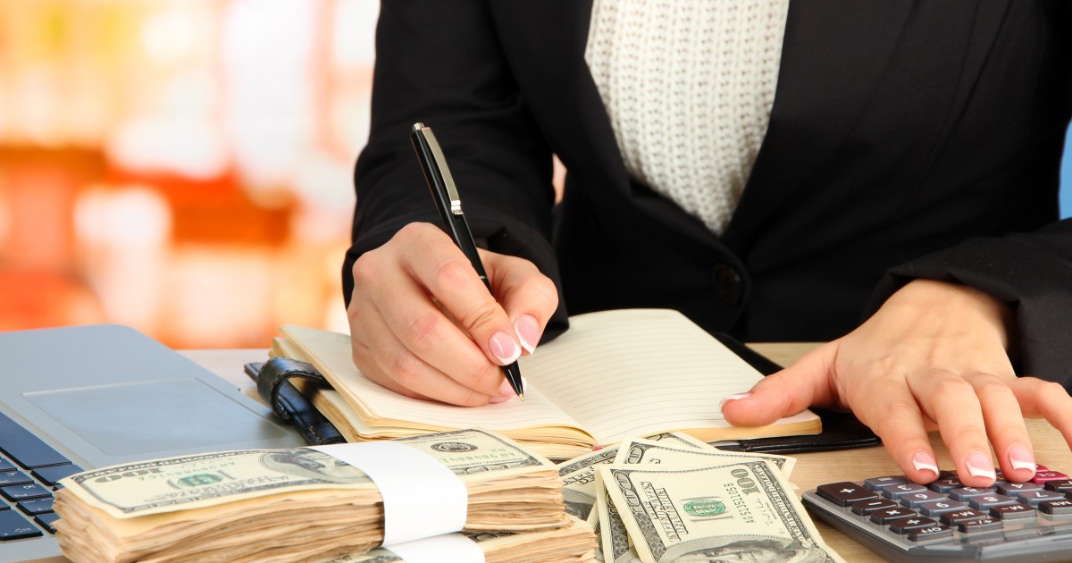Candy Bar Accounting: Keeping track of school booster club fundraising Lady counting cash and bookkeeping