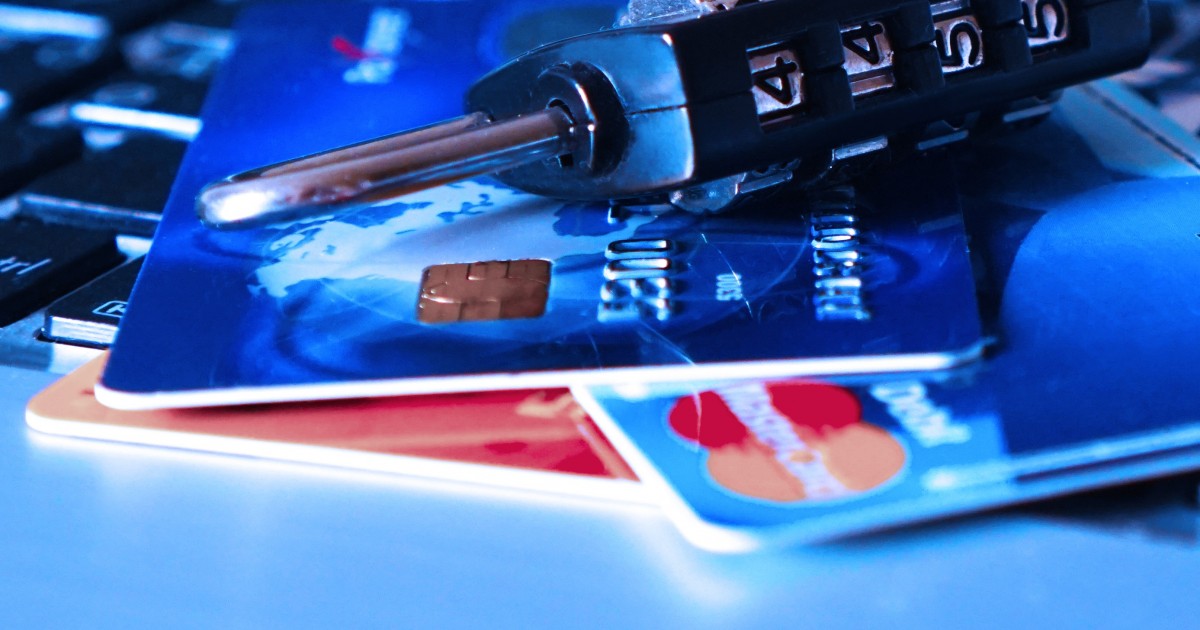 The Embezzler Next Door: Preventing Theft in School Support Organizations Lock sitting on credit cards illustrating security