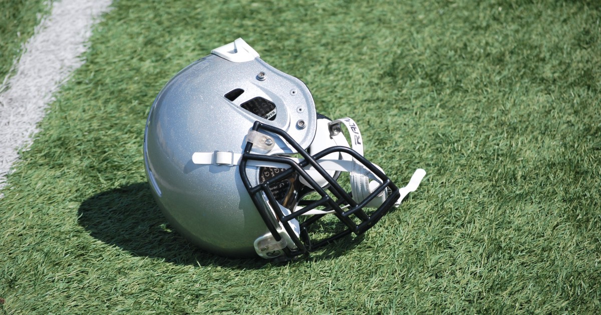 Who Buys the Helmets? Football helmet laid carelessly in the grass