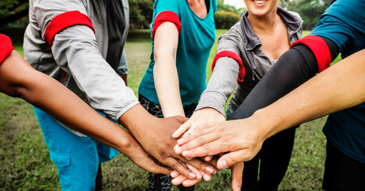 #parentboostersmatter Lots of hands stacked in a circle showing a team mentality