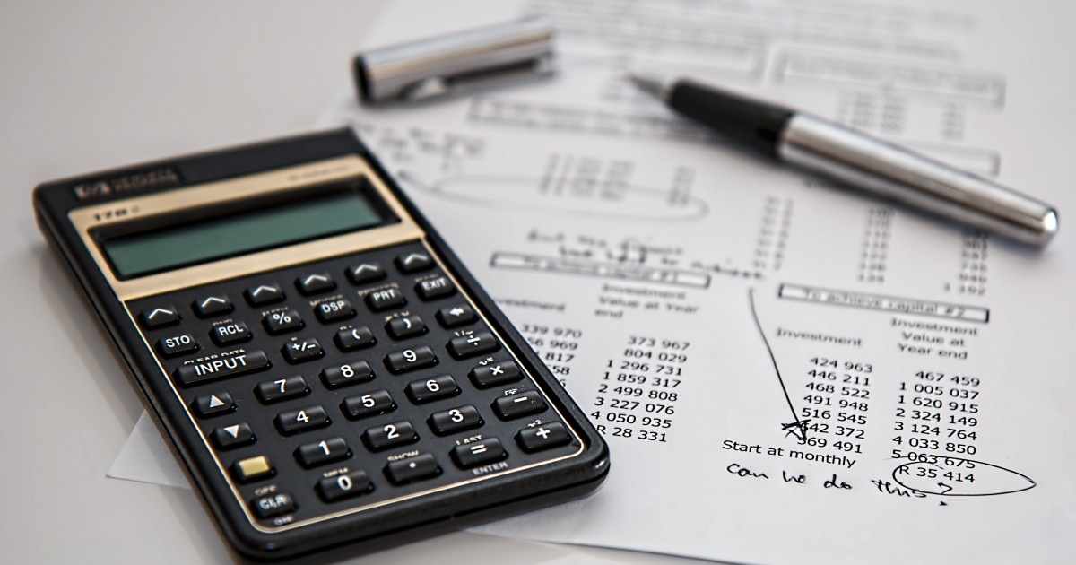 Guide to Conducting an Internal Financial Review Calculator and financial document with handwritten notes