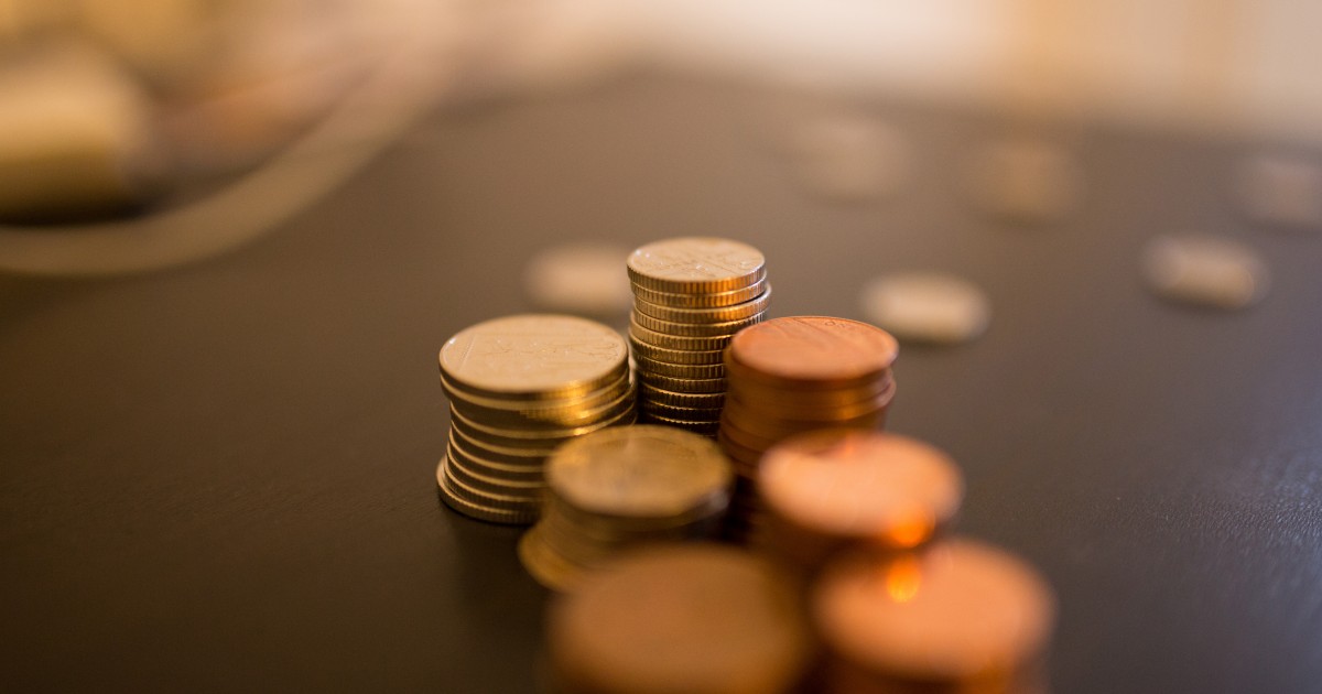 Theft Downloads Stack of coins on desk with blur effect