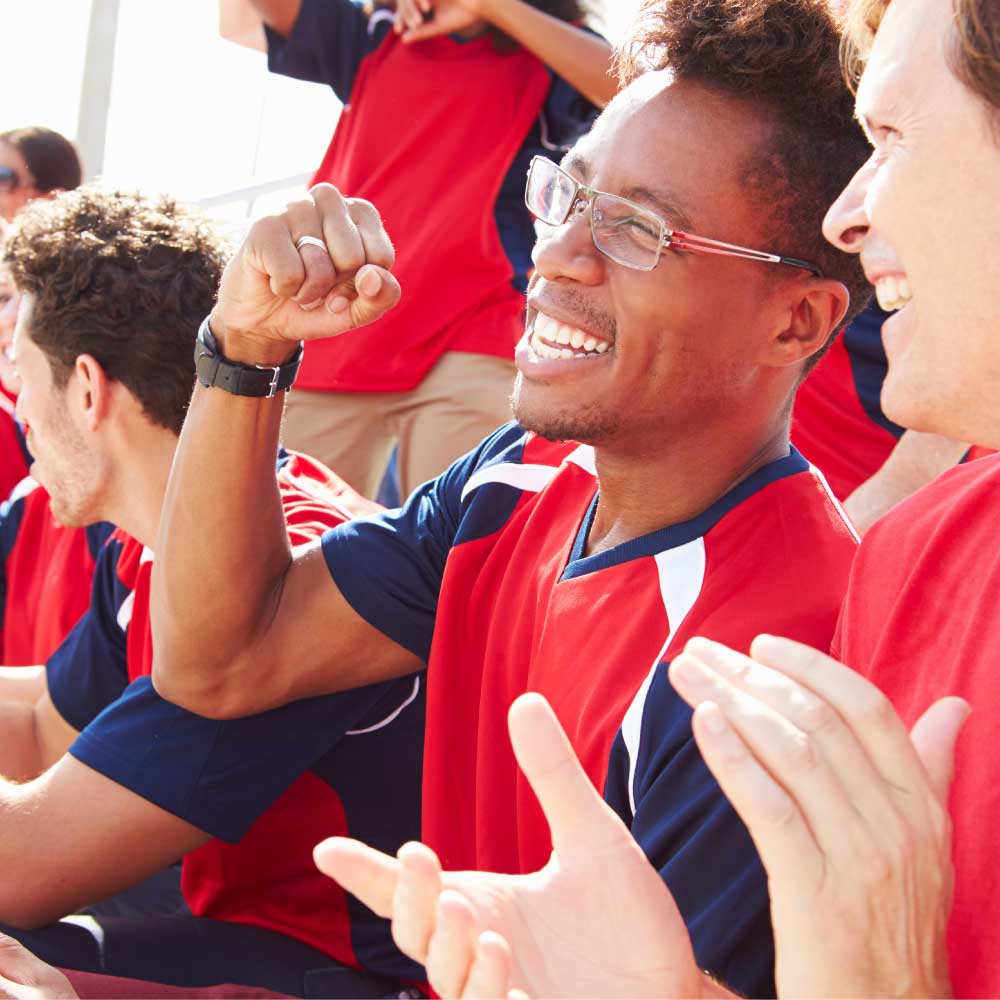 adults cheering for their kids' team